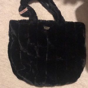 A black furry Victoria secret bag with the tag.